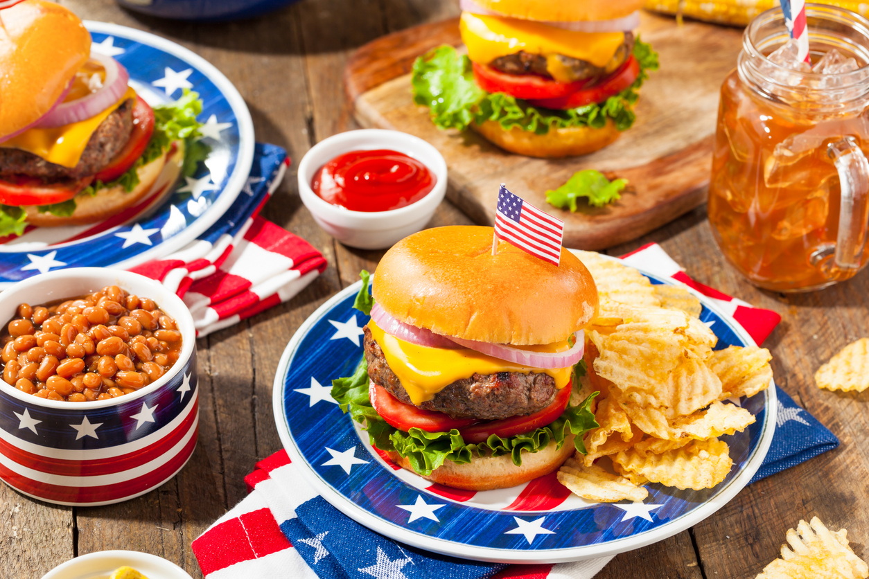 a hamburger picnic on a picnic table