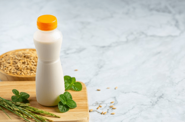 Image-of-a-bottle-filled-with-rice-milk-on-a-marble-white-shelf