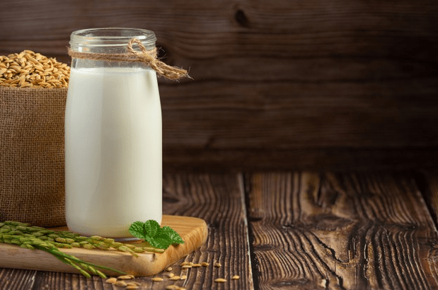 Image-of-rice-milk-bottle-with-rice-plant-on-a-wooden-board