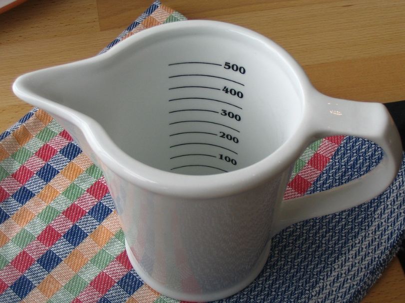 a-white-adjustable-measuring-cup
