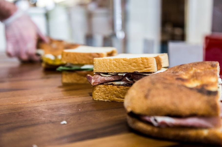 lined-up-sandwiches-on-brown-wooden-table
