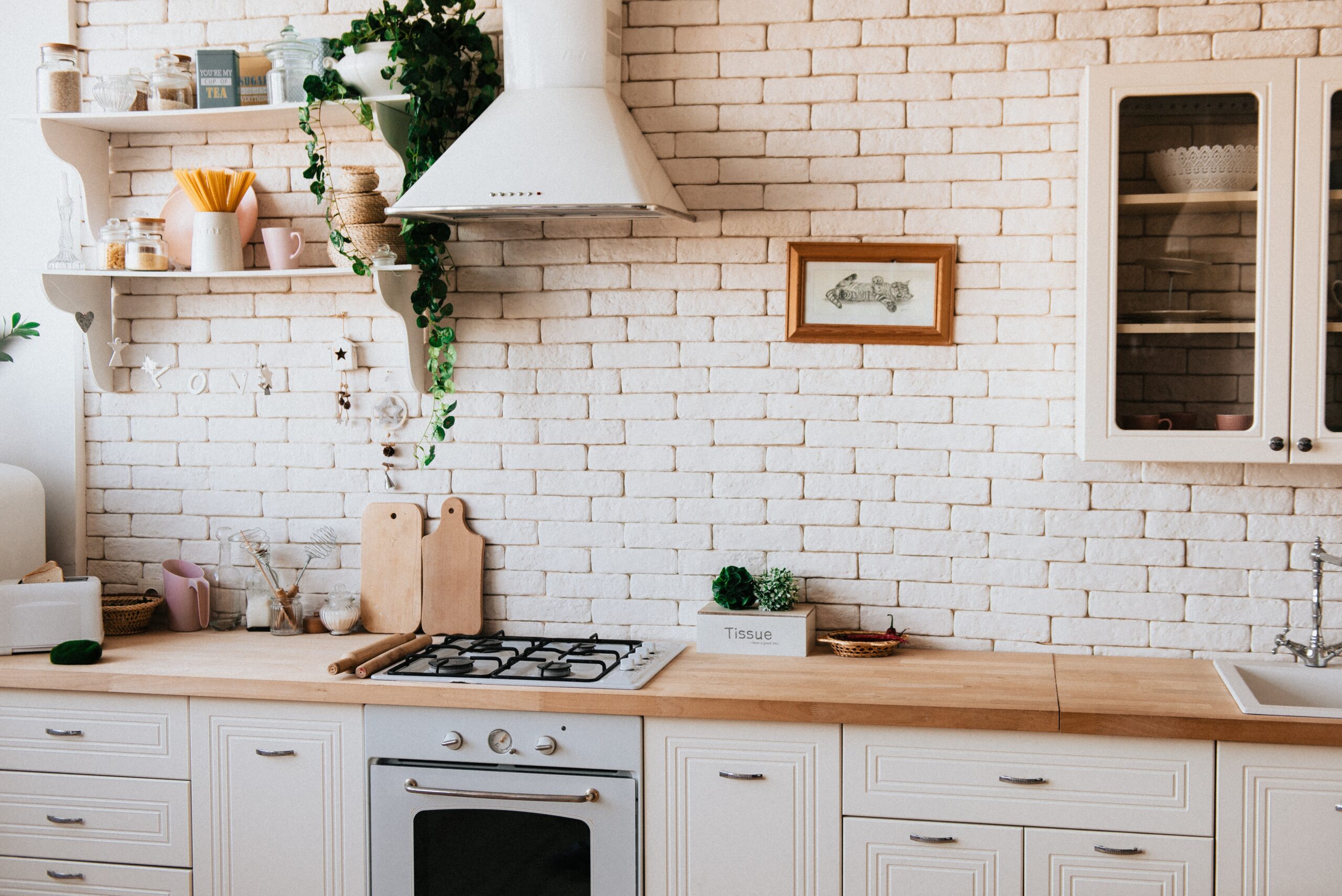 A bright kitchen with white brick walls